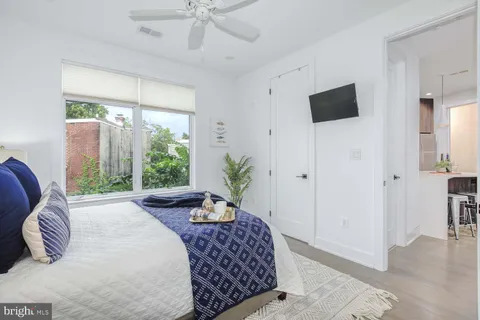 a bedroom with a large bed and a window