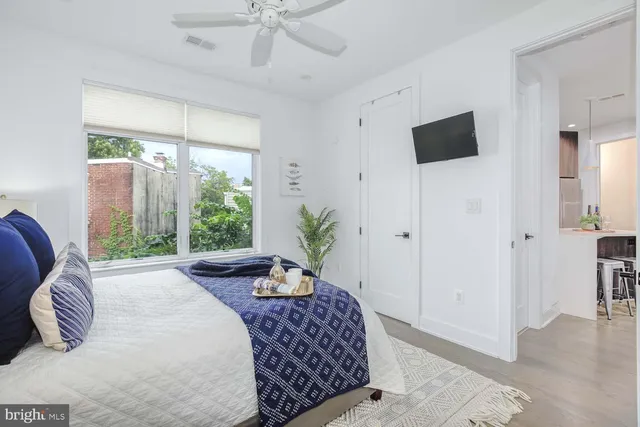 a bedroom with a large bed and a window