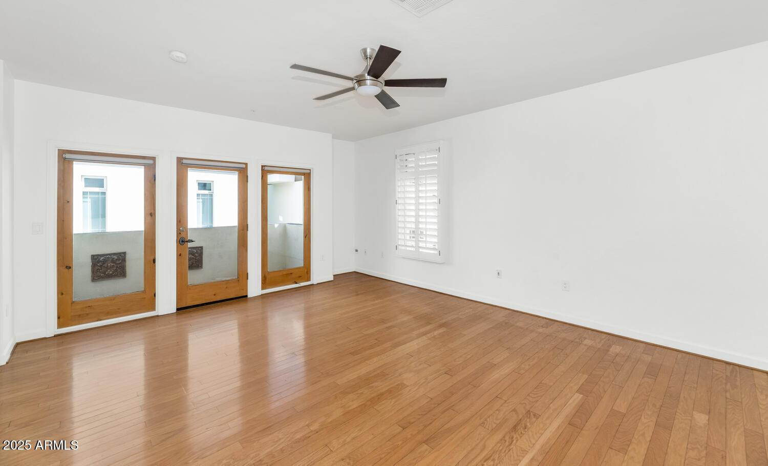 229 West Portland Street Phoenix, AZ 85003 - Photo 13 of 26 an empty room with wooden floor and windows