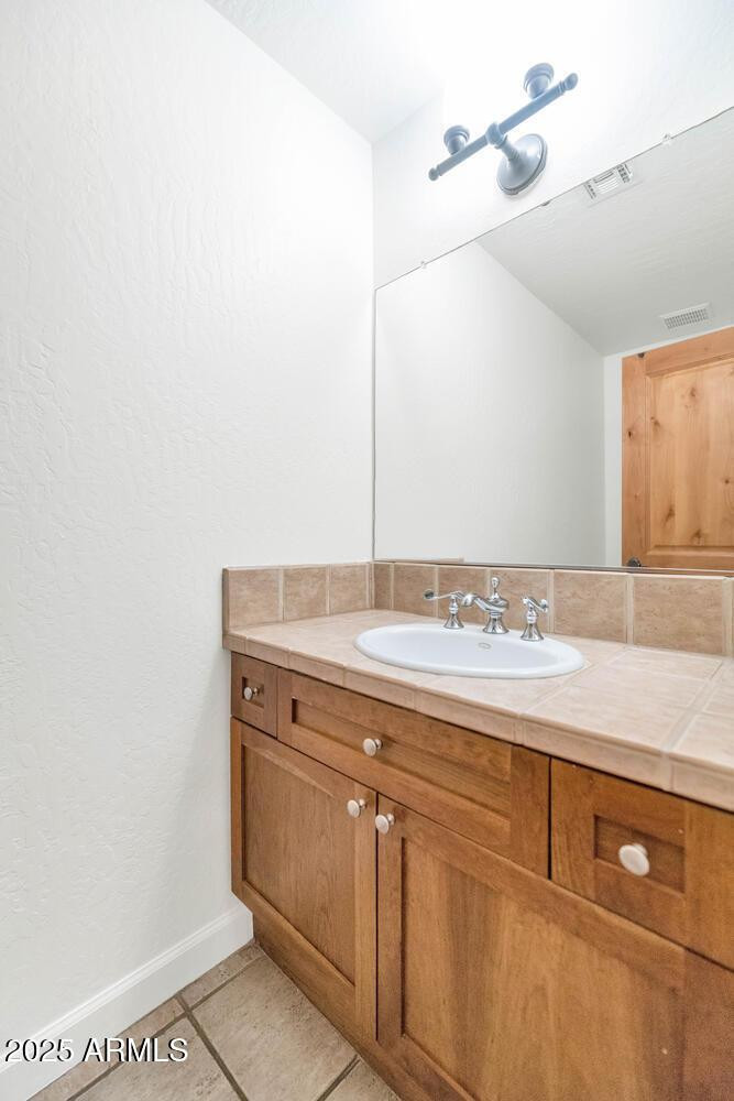 229 West Portland Street Phoenix, AZ 85003 - Photo 14 of 26 a bathroom with a sink and vanity