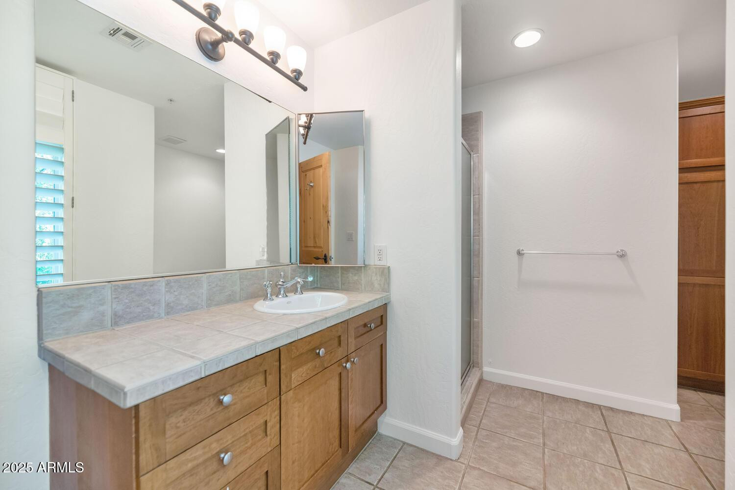 229 West Portland Street Phoenix, AZ 85003 - Photo 22 of 26 a bathroom with a sink and a mirror