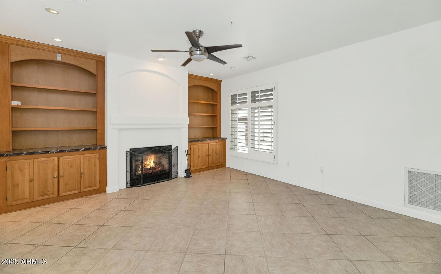 229 West Portland Street Phoenix, AZ 85003 - Photo 3 of 26 a view of an empty room with a fireplace and a window