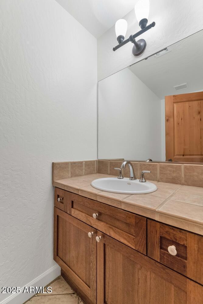 229 West Portland Street Phoenix, AZ 85003 - Photo 4 of 26 a bathroom with a granite countertop sink and a mirror