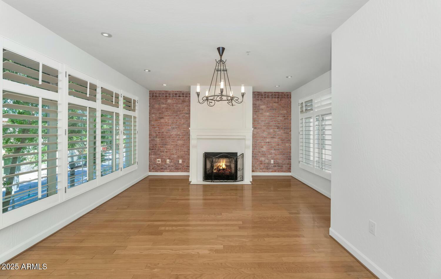 229 West Portland Street Phoenix, AZ 85003 - Photo 5 of 26 a view of a livingroom with a fireplace large windows and a chandelier