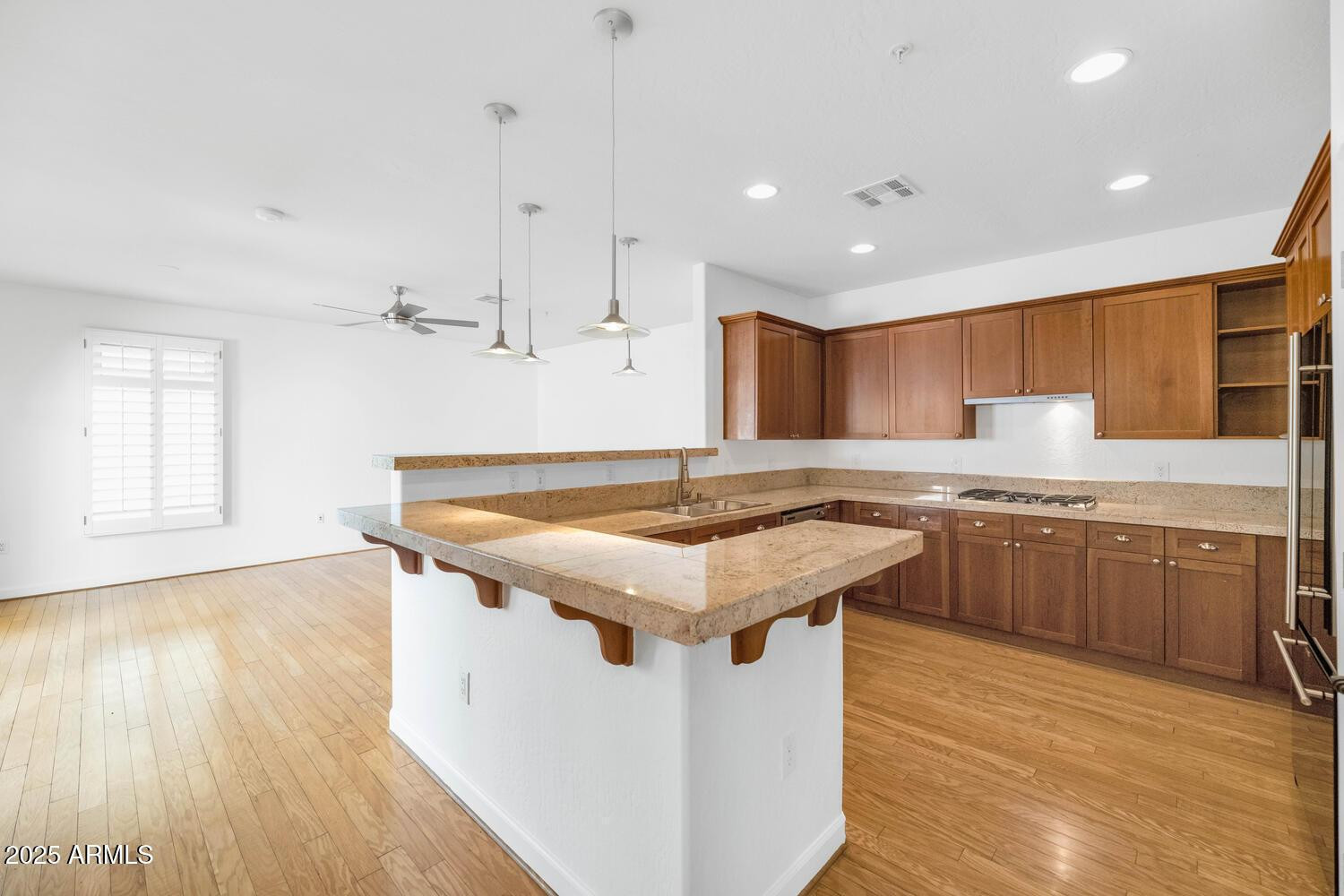 229 West Portland Street Phoenix, AZ 85003 - Photo 9 of 26 a kitchen with a stove a sink a refrigerator and wooden floor