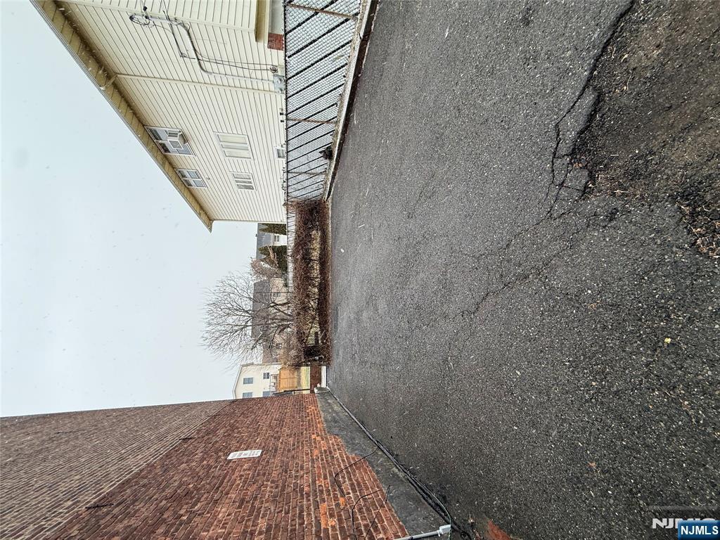 207 Westervelt Place, Unit 2 Lodi, NJ 07644 - Photo 12 of 13 a view of a truck parked in back of a house