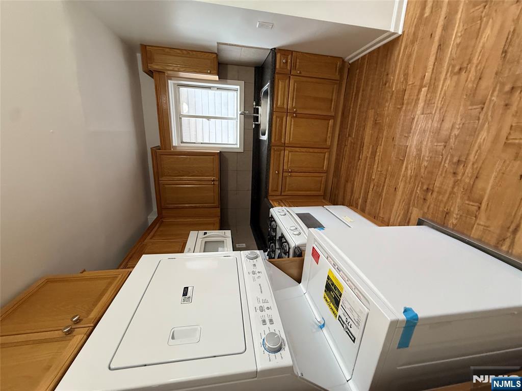 207 Westervelt Place, Unit 2 Lodi, NJ 07644 - Photo 3 of 13 a kitchen with a sink a stove cabinets counter space and a window