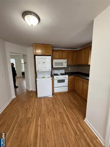 a view of a kitchen with microwave and cabinets