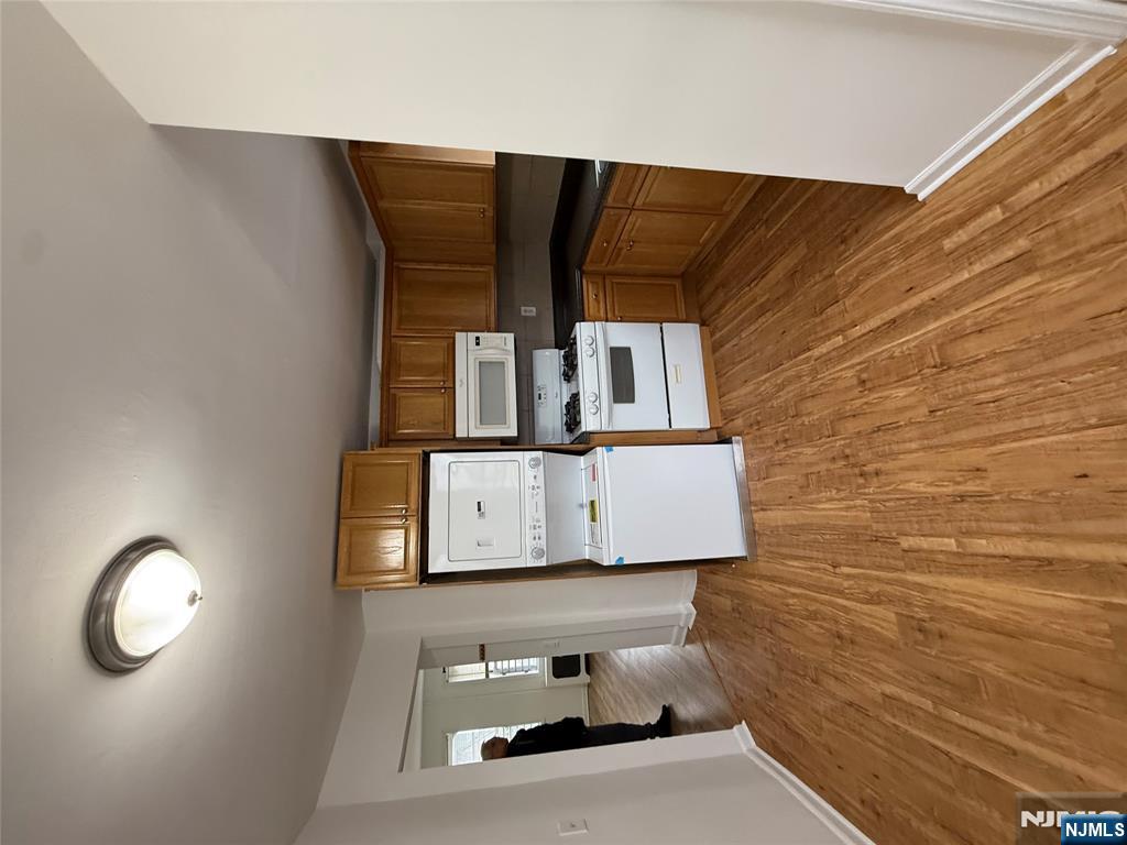 207 Westervelt Place, Unit 2 Lodi, NJ 07644 - Photo 4 of 13 a view of a kitchen with microwave and cabinets