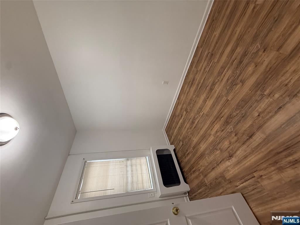 207 Westervelt Place, Unit 2 Lodi, NJ 07644 - Photo 9 of 13 a view of empty room with wooden floor and fan