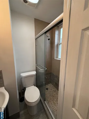 a bathroom with a toilet and a shower