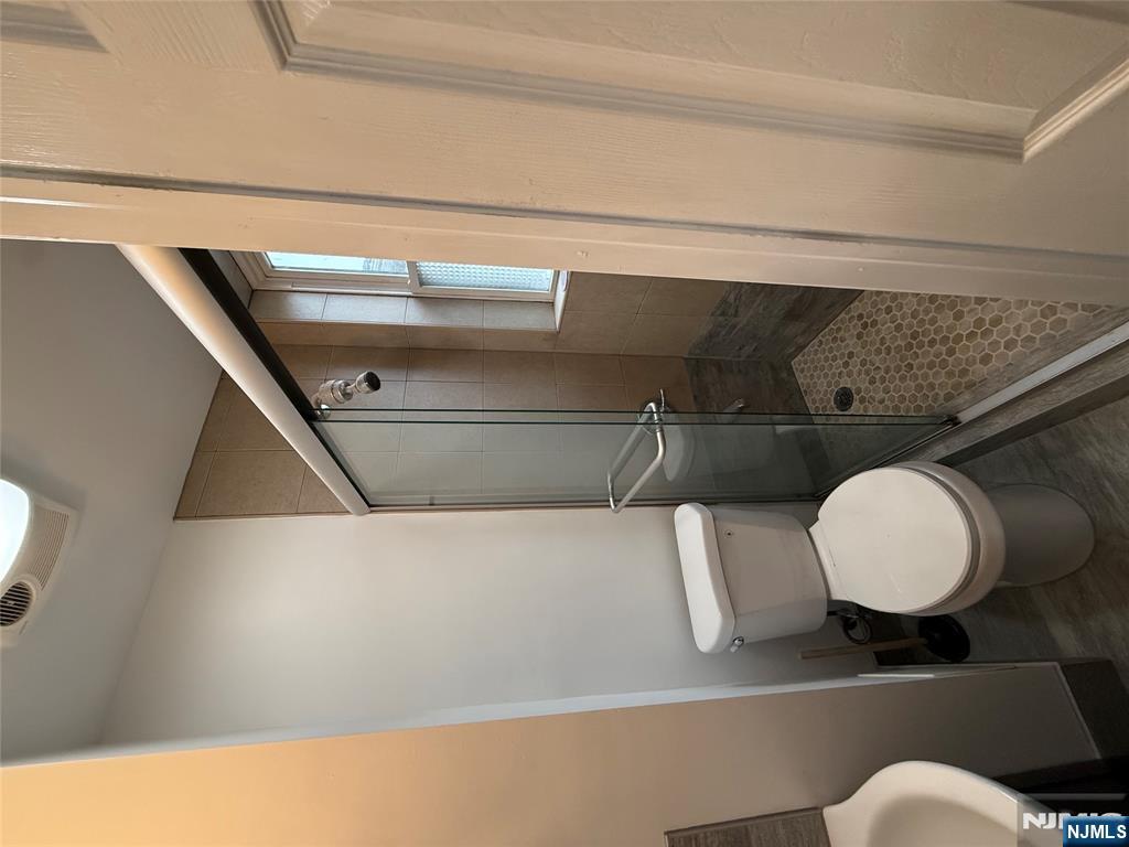 207 Westervelt Place, Unit 2 Lodi, NJ 07644 - Photo 10 of 13 a bathroom with a toilet and a shower