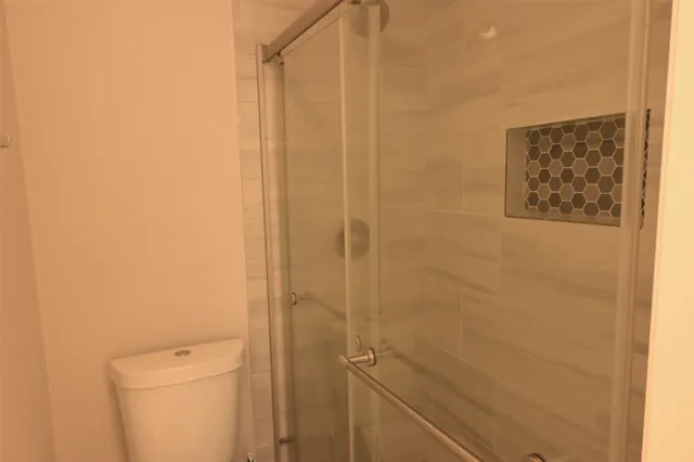 a bathroom with a shower and a toilet