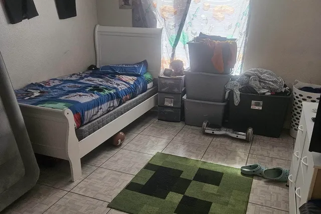 a bedroom with a bed and a window