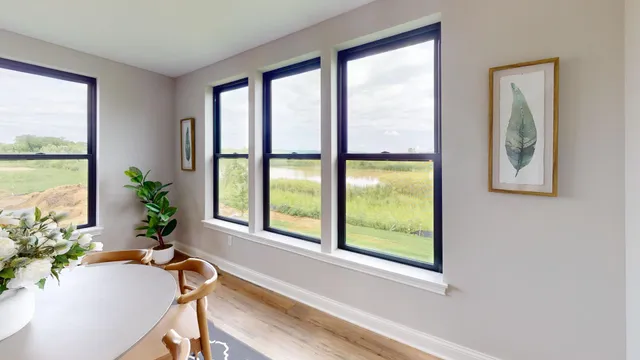 a view of a room that has a large window and a potted plant