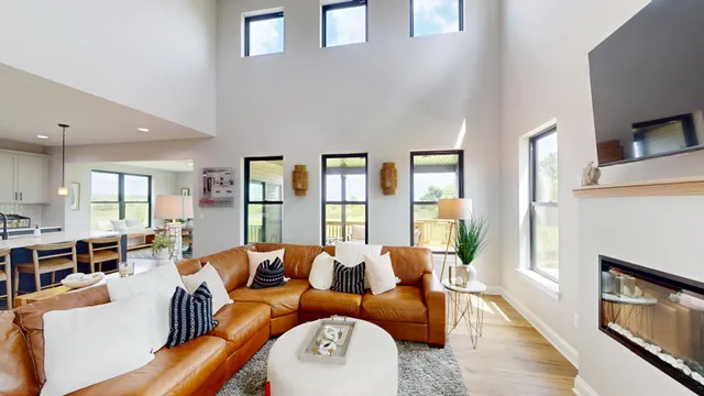 a living room with furniture fireplace and wooden floor