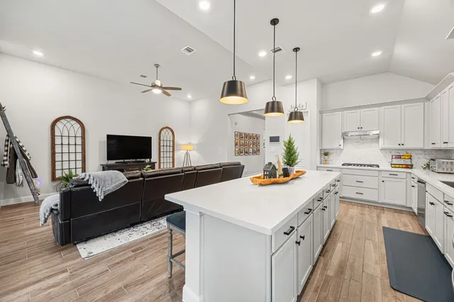 a kitchen with appliances a sink and cabinets