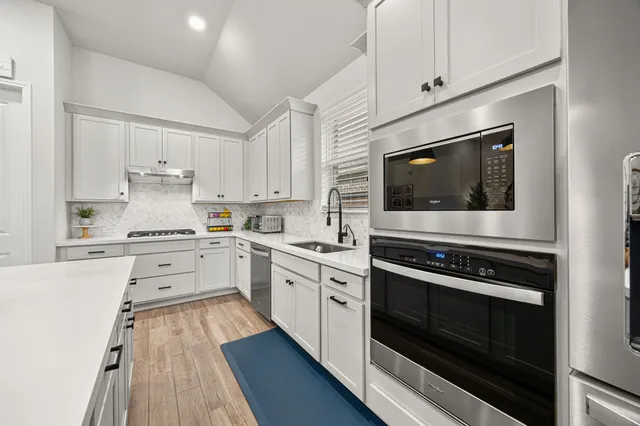 a view of a dining room with furniture wooden floor and chandelier