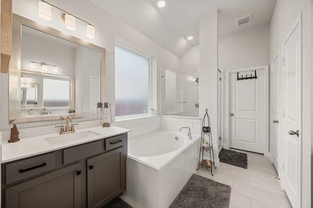 a bathroom with a bathtub and a window
