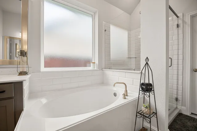 a bathroom with a bathtub and a shower