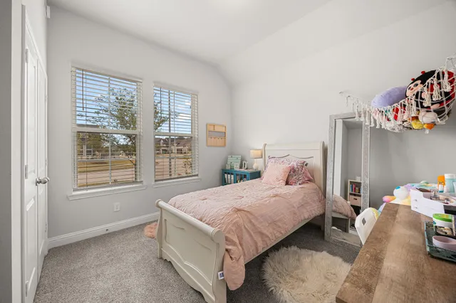 a bedroom with a bed and a desk
