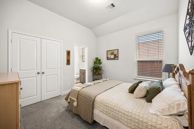 a bathroom with a sink mirror vanity and toilet