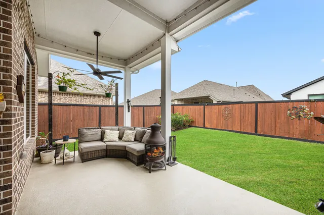 a view of a backyard with wooden fence