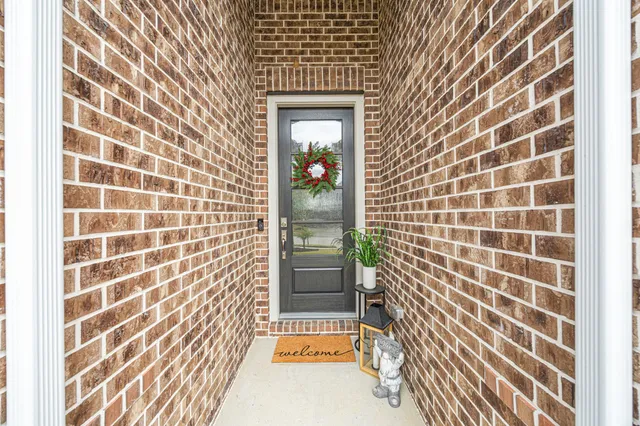 a hallway with flowers on wooden floor