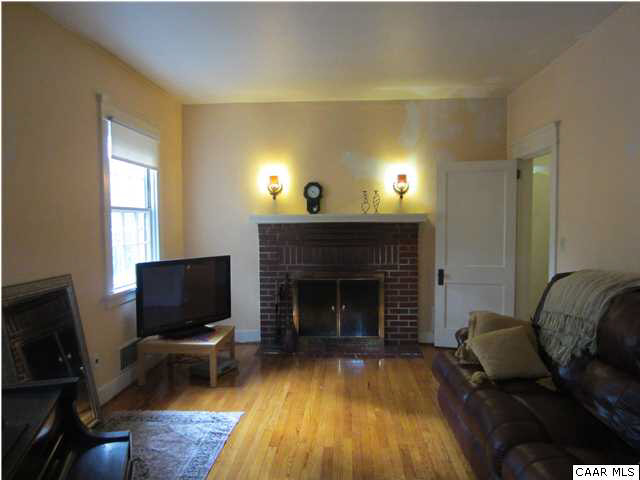 201 Cleveland Avenue Charlottesville, VA 22903 - Photo 3 of 13 a living room with furniture and a fireplace