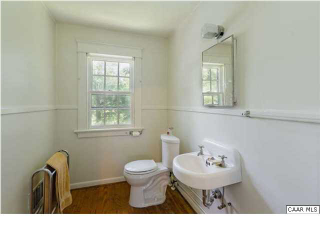 201 Cleveland Avenue Charlottesville, VA 22903 - Photo 10 of 13 a bathroom with a sink toilet a mirror and a window