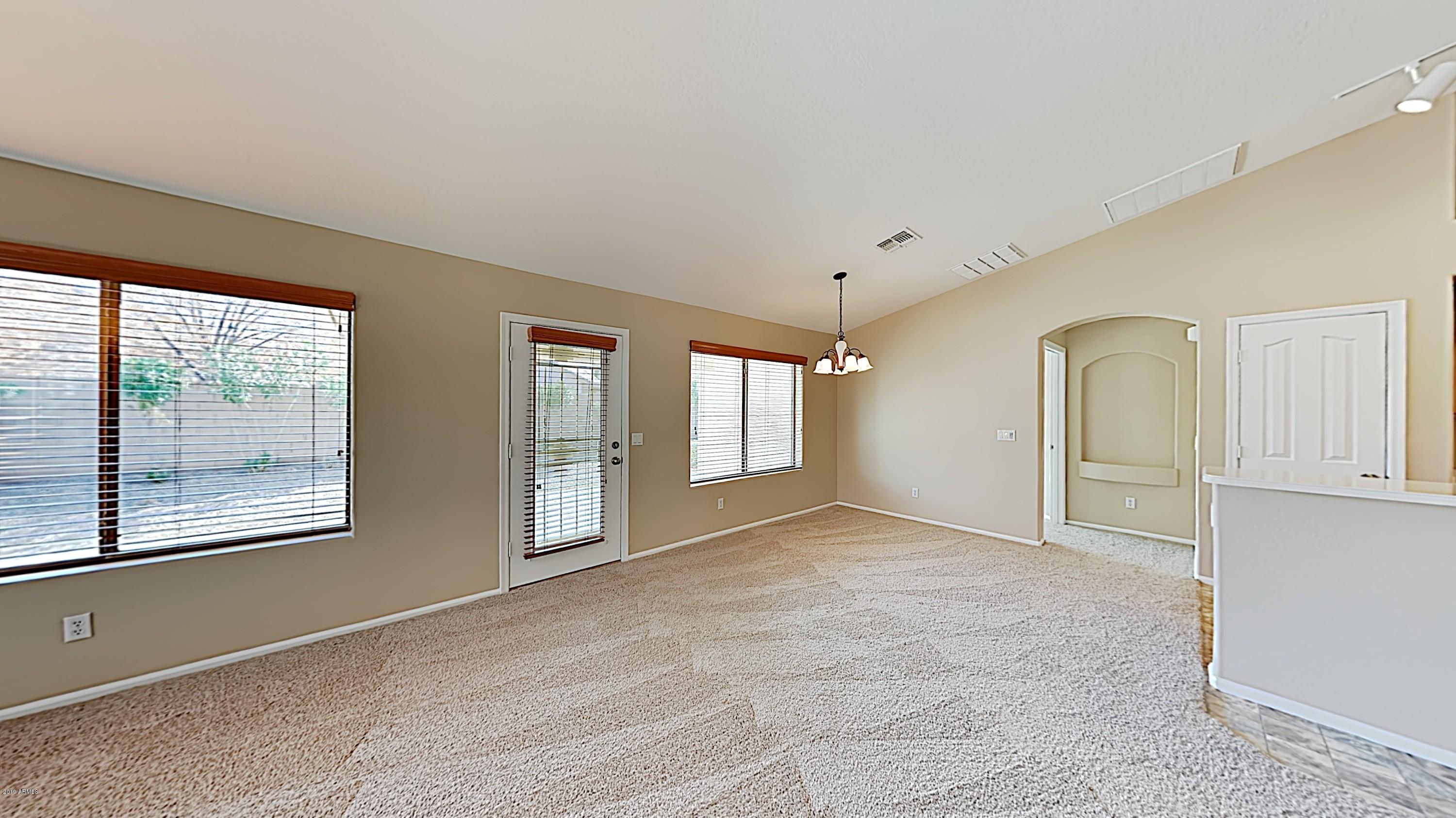 43905 Roth Road Maricopa, AZ 85138 - Photo 3 of 16 a view of an empty room with window and cabinet