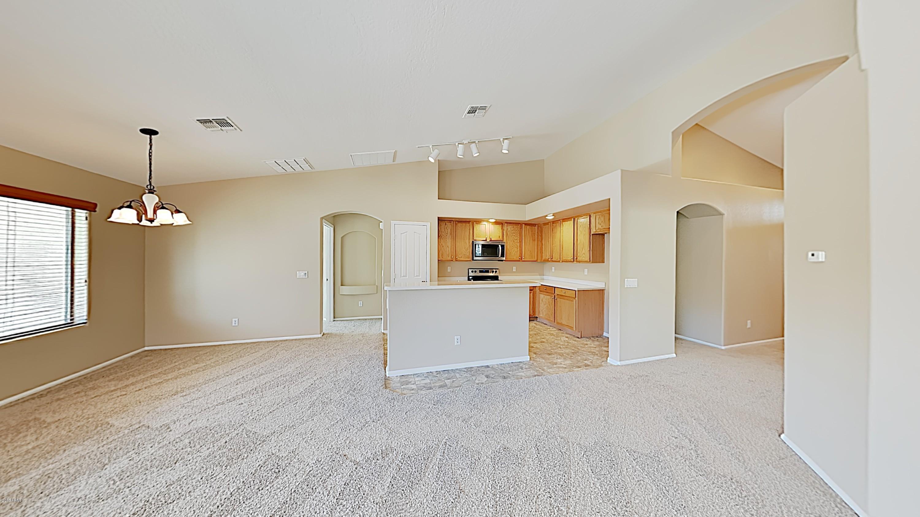 43905 Roth Road Maricopa, AZ 85138 - Photo 6 of 16 a view of a kitchen with a sink and dishwasher wooden floor