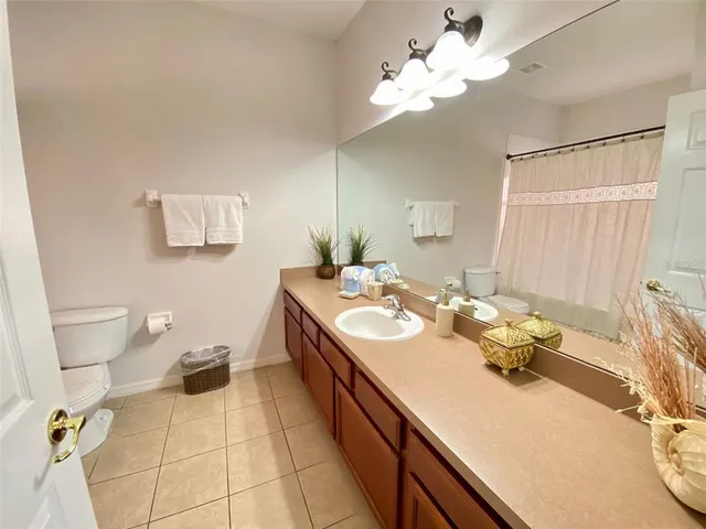 a view of a hallway with a livingroom and furniture