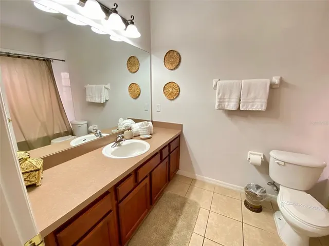 a bathroom with a sink mirror vanity and toilet