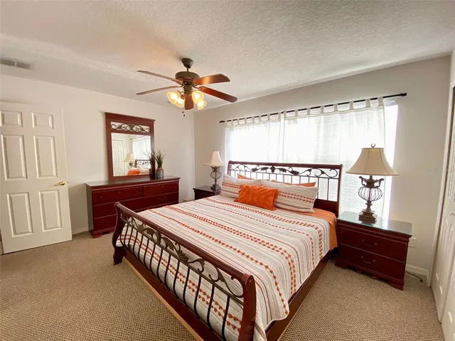 a bathroom with a granite countertop sink a toilet and a mirror