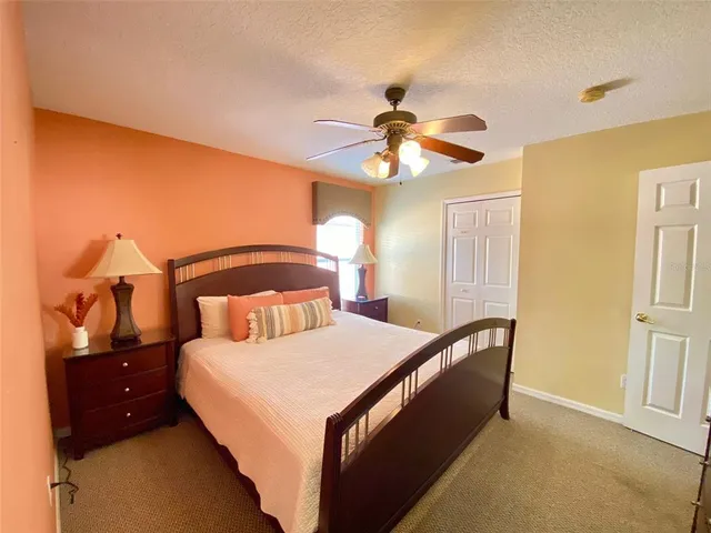 a bedroom with a large bed and a chandelier