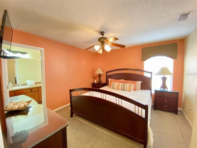 a bedroom with three beds and a couch