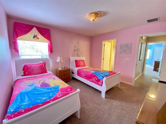 a bedroom with two beds and painted walls