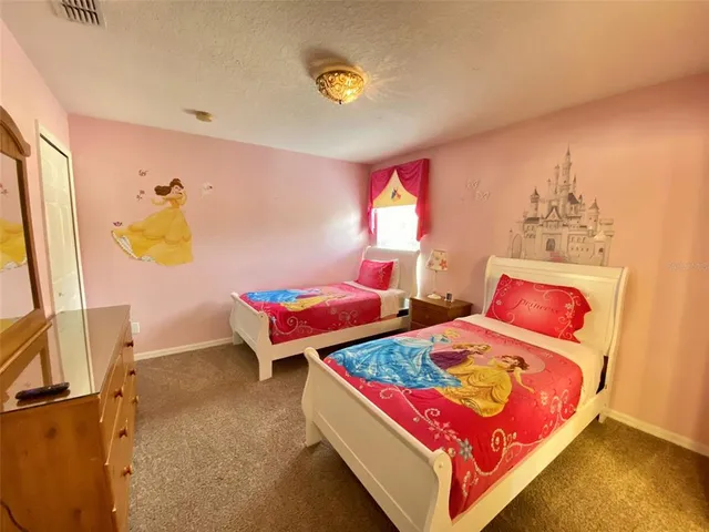 a bedroom with a bed and dresser with mirror