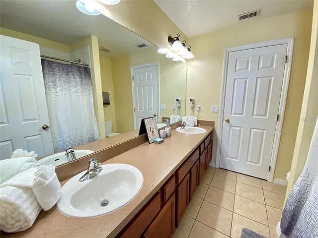 a bedroom with furniture and a flat screen tv