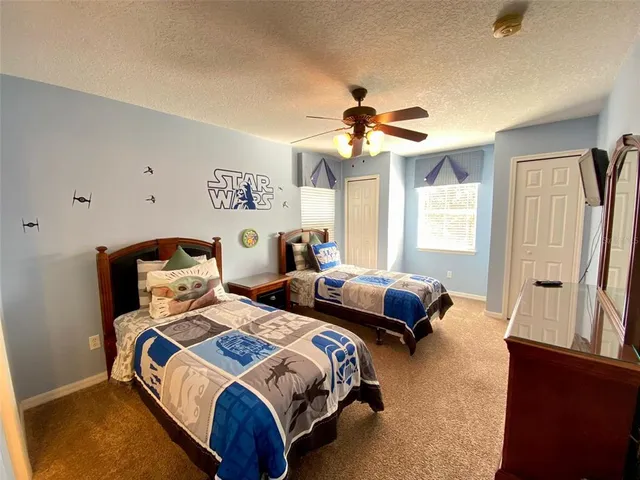 a bedroom with two beds and a chandelier