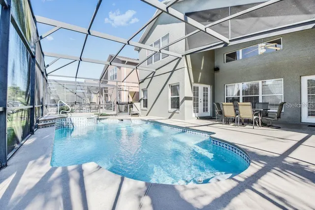 a bedroom with furniture and a large window