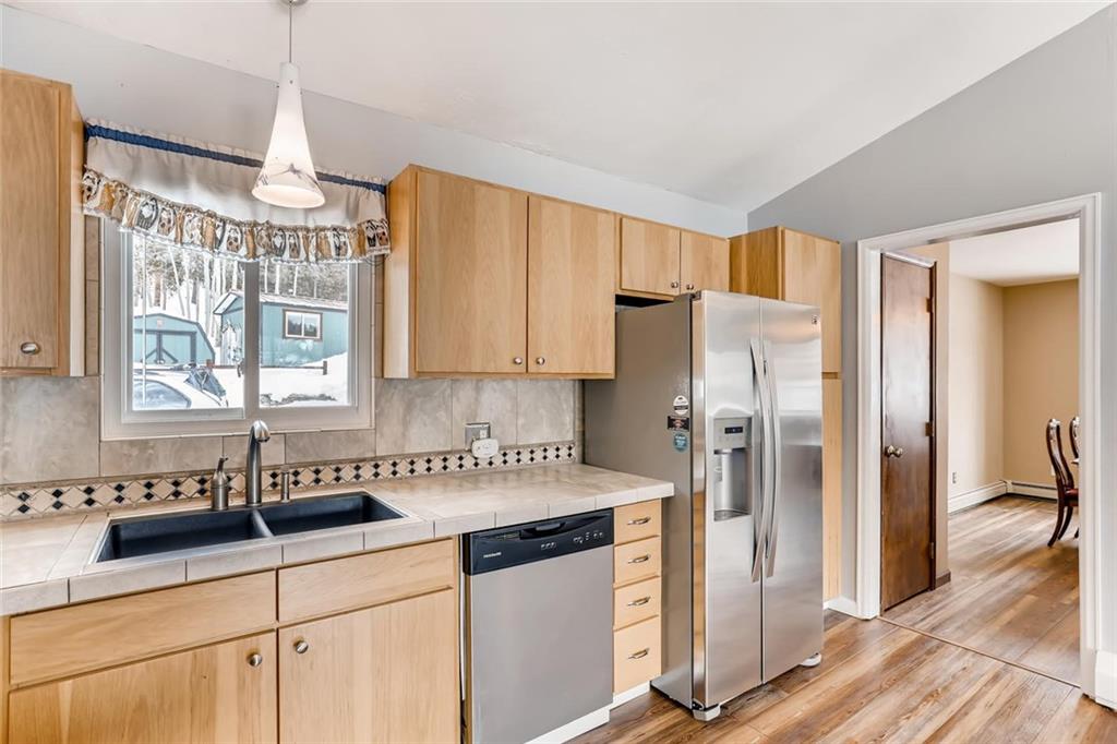 125 Reiling Road Breckenridge, CO 80424 - Photo 11 of 35 a kitchen with a refrigerator a sink and cabinets