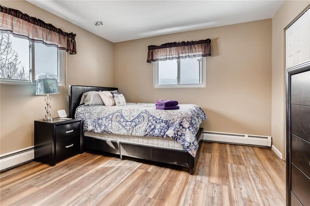125 Reiling Road Breckenridge, CO 80424 - Photo 13 of 35 a bedroom with a bed and wooden floor