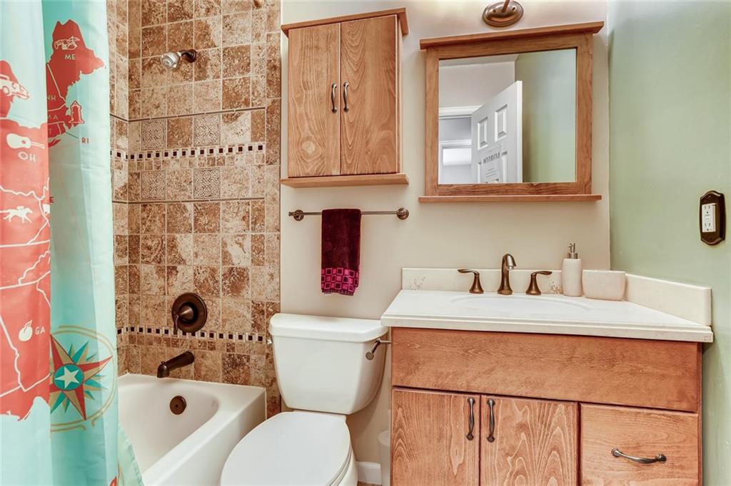 125 Reiling Road Breckenridge, CO 80424 - Photo 21 of 35 a bathroom with a sink a toilet and shower curtain