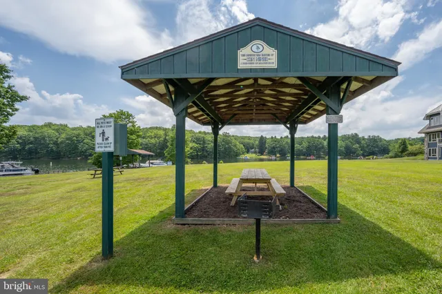 a view of a swimming pool with an outdoor seating and a garden