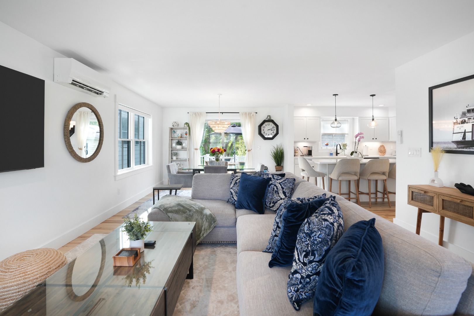 33 Lagoon Pond Road Vineyard Haven, MA 02568 - Photo 9 of 42 a living room with furniture a clock and a mirror