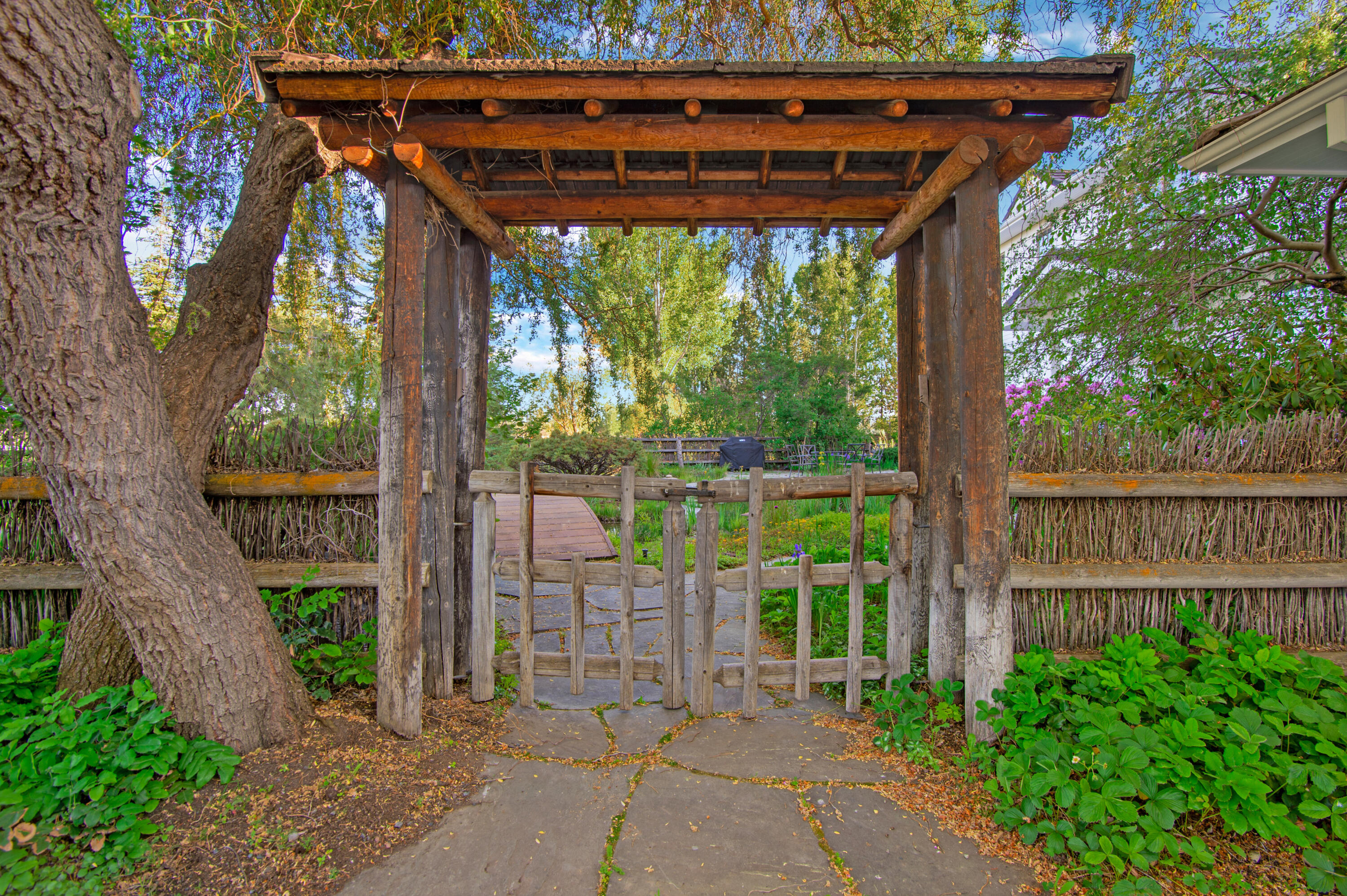 64950 Collins Road Bend, OR 97703 - Photo 57 of 87 a view of a patio with table and chairs and a large tree