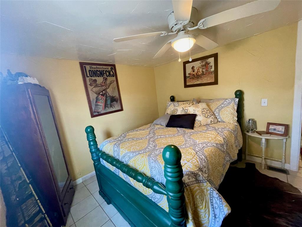 2334 San Bar Road, Unit 13 Graford, TX 76449 - Photo 17 of 33 a bedroom with a bed and a chandelier