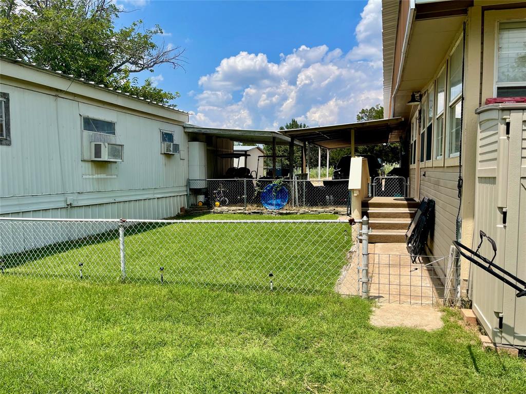 2334 San Bar Road, Unit 13 Graford, TX 76449 - Photo 24 of 33 a front view of a house with a yard